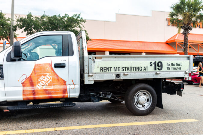 Naples, USA – August 14, 2021: The Home Depot store parking lot with sign on rental truck for rent me starting at 19 dollars for 75 minutes in Naples southwest Florida